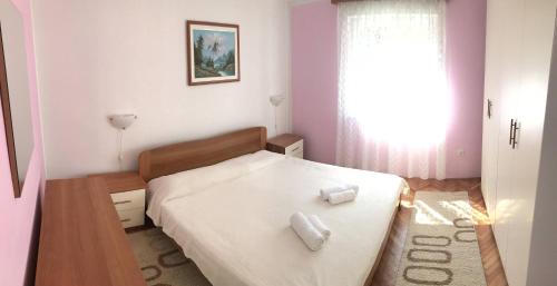 a bedroom with a bed with two towels on it at Luka in Pula