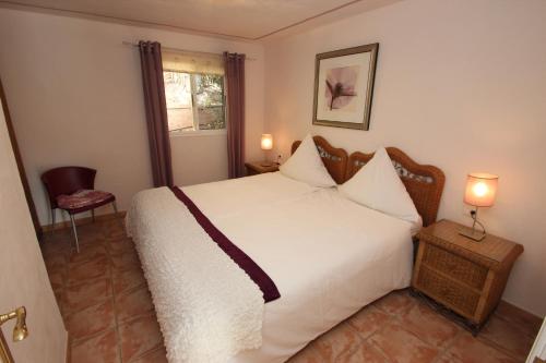 吉亞德索拉的住宿－Casa Julia Finca Montimar，卧室设有一张白色大床和一扇窗户。