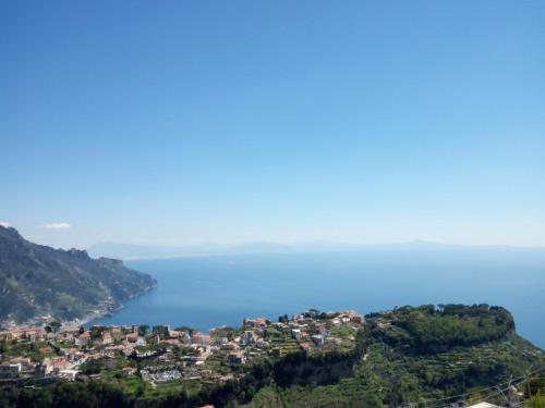 an aerial view of a town on a hill next to the water at B&B Oliva in Scala