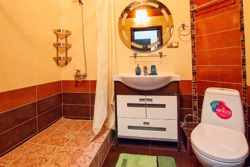 a bathroom with a sink and a toilet and a mirror at Mini Hotel Bereket Dip in Astana