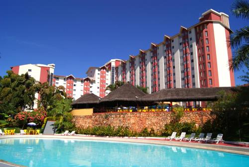 a hotel with a swimming pool in front of a building at Hot Springs Hotel - Via Conchal in Caldas Novas