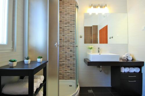 a bathroom with a sink and a glass shower at Villa Vedran in Podgora