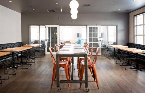 a large dining room with wooden tables and chairs at Coast Canmore Hotel & Conference Centre in Canmore