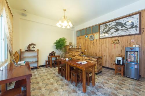 a dining room with a table and a refrigerator at Free Time B&B in Taitung City