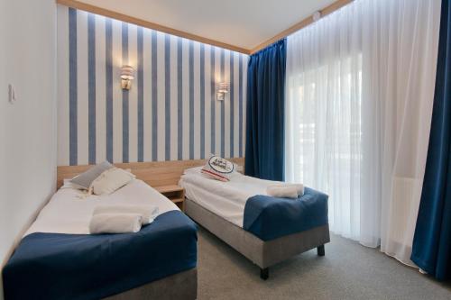a hotel room with a bed and two nightstands at B&B Molo in Sopot