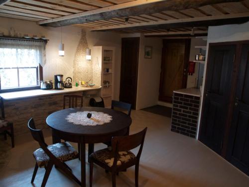a kitchen and dining room with a table and chairs at Aaduaida Holiday House in Suure-Rootsi