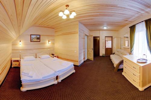 a large room with two beds in a room at Forest House in Tatariv