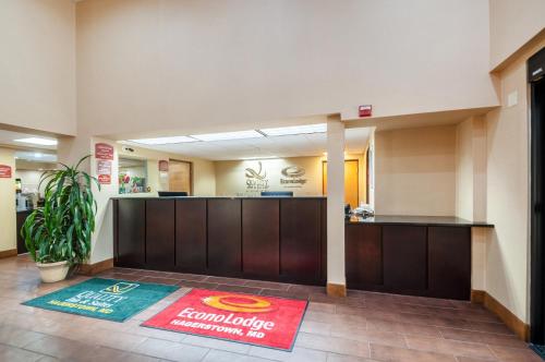 a hotel lobby with a reception desk and a rug at Econo Lodge Hagerstown I-81 in Hagerstown