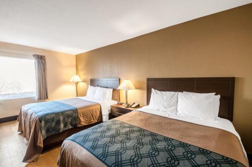 a hotel room with two beds and a window at Econo Lodge Hagerstown I-81 in Hagerstown