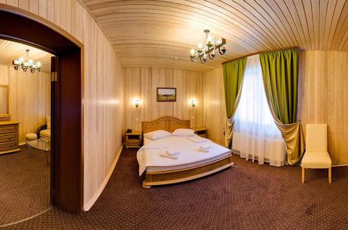 a bedroom with a large bed and a window at Forest House in Tatariv