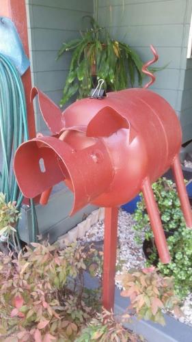 a red bird statue in front of a house at Rose City Caravan Park in Warwick
