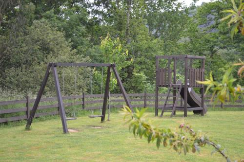 two swings in the grass in a park at Casona del Nansa in Herrerias