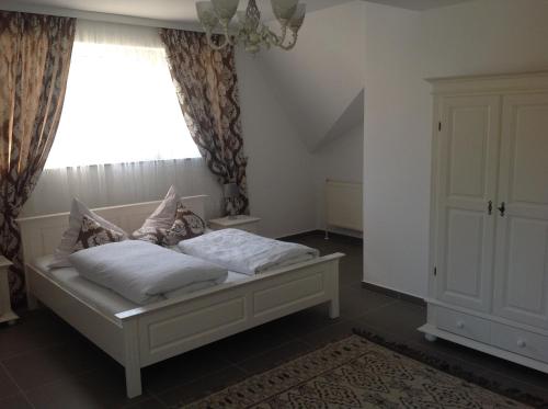 a bedroom with a bed and a window at Casa Avram in Suceviţa
