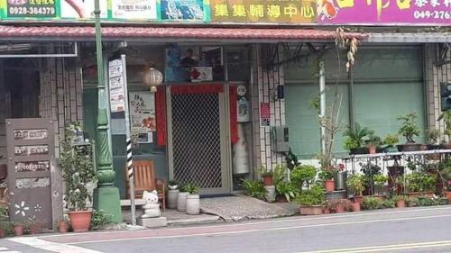 a building with plants in front of it at 集集藝術家背包客之家Jiji Art Backpackers Hostel in Jiji