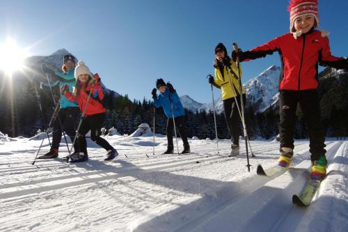 a group of people on skis in the snow at Hotel Achentalerhof in Achenkirch