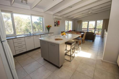 a large kitchen with a table and a dining room at The Lakes Beachfront Holiday Park in Lakes Entrance