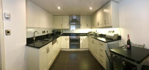 
a kitchen with a stove top oven and a sink at No. 14 in St. Andrews
