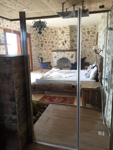 a bedroom with a bed in a room with stone walls at Beso Patara in Patara