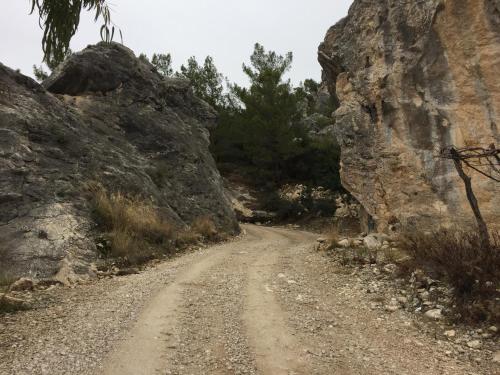a dirt road next to a rocky mountain at Beso Patara in Patara