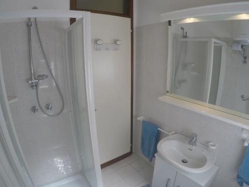 a bathroom with a shower and a toilet and a sink at Condominio Sole - Agenzia Cocal in Caorle