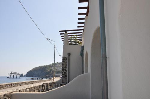 a white building with a view of the beach at NerOssidiana in Acquacalda