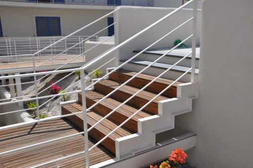 a staircase with white railings on a building at NerOssidiana in Acquacalda