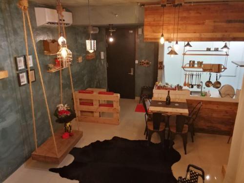 a living room with a table and a dining room at De Houz @ Setia Alam Trefoil Homestay in Shah Alam