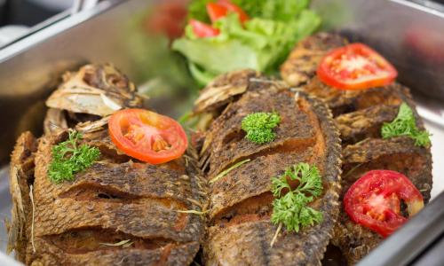 a tray of food with tomatoes on top of it at Global Towers Hotel & Apartments in Colombo