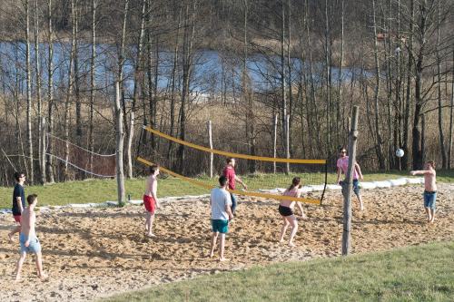 a group of people playing a game of volley ball at Dabintos slėnis in Sumiliszki