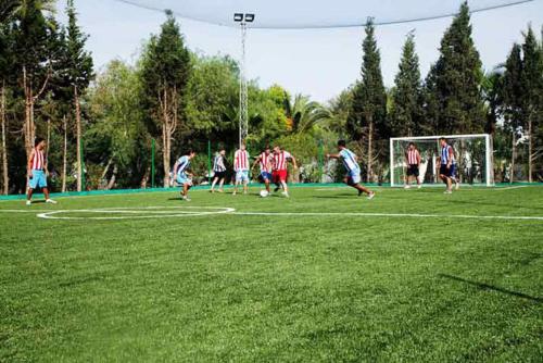 a group of people playing soccer on a field at Sahara Beach Aquapark Resort in Monastir