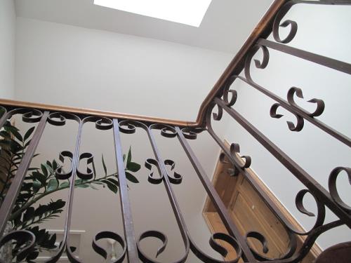 a stairwell with a metal railing with a wooden box at Maébrilu Camargue Provence in Salin-de-Giraud