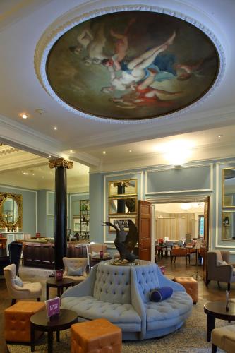 a living room with a couch and a painting on the ceiling at Hotel du Vin Cannizaro House Wimbledon in London