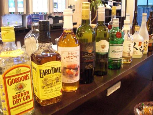 a bunch of bottles of alcohol on a shelf at Kuretake-Inn Fujisan in Fuji