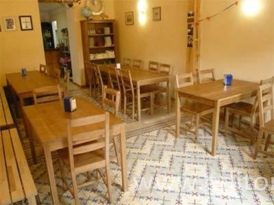 a dining room with wooden tables and chairs at Albergue San Bruno in Moratinos
