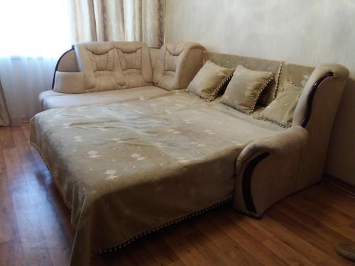 a couch sitting in a living room with a couch at Daily apartment Sumy in Sumy