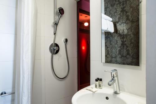 a bathroom with a shower and a sink at Le Quartier Bercy-Square in Paris
