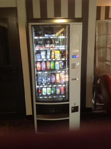 a refrigerator filled with lots of sodas and drinks at BRIT Hotel - Montsoult La Croix Verte in Baillet-en-France