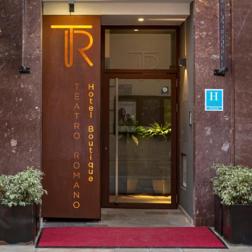 an entrance to a building with a sign on the door at Hotel Boutique Teatro Romano in Málaga