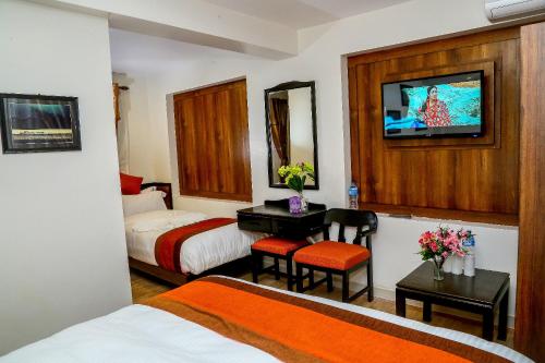 Postel nebo postele na pokoji v ubytování Hotel Himalayan Oasis