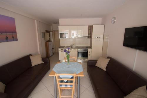 a living room with a couch and a table at Apartments Villa Mare in Krk
