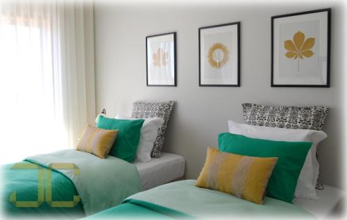 a living room with a couch and pillows at Country Apartment by JC in Porto