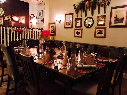 a long wooden table in a restaurant with chairs and a tableablish at The Woolly Sheep Inn in Skipton