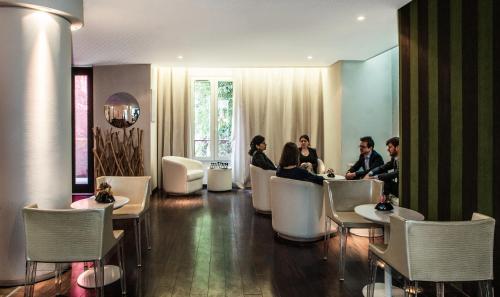 a group of people sitting in a hotel lobby at Le Quartier Bercy-Square in Paris