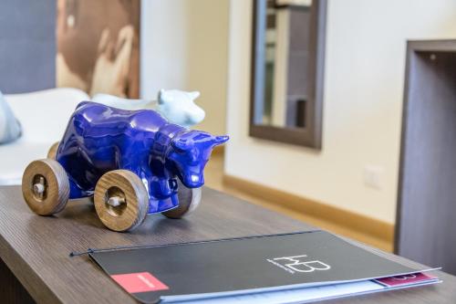 a blue toy train sitting on a table next to a laptop at HB Aosta Hotel & Balcony SPA in Aosta