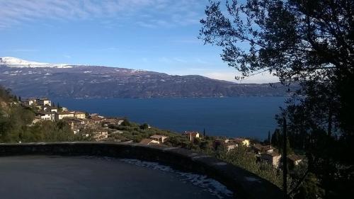 a view of a body of water with a mountain at Cà del borgo Historic Village in Toscolano Maderno