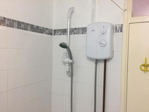 a shower in a bathroom with a shower head at Two bedroom apartment in Royal Greenwich in London