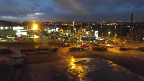 a view of a parking lot at night at 247Hotel in Oldham