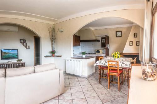 a living room with a table and a kitchen at Appartamenti Bellavista - HelloElba in Portoferraio