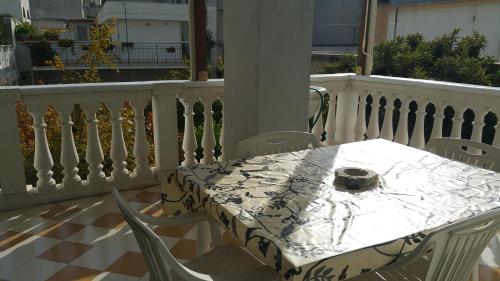 a white table and chairs on a balcony at Palazzo Lagioia in Triggiano