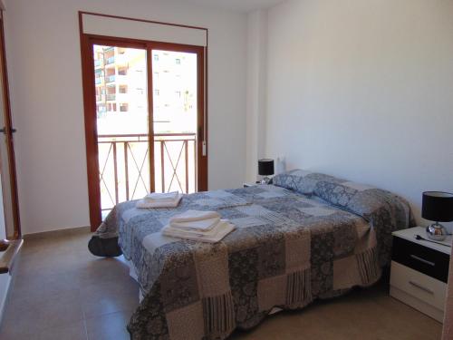 a bedroom with a bed with towels on it at Duplex 8 in Puerto de Mazarrón